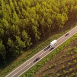 Cars,And,Truck,On,The,Road,Through,Forest,Landscape,,Aerial