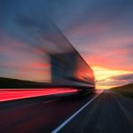 Blurring.,A,Large,Truck,Is,Driving,Along,The,Highway,At