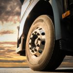 Big,Truck,Wheel,Tires.,Semi,Truck,Parked,At,Sunset,Sky.