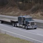 Flat,Bed,Semi,Tractor,Trailer,Truck,On,The,Highway
